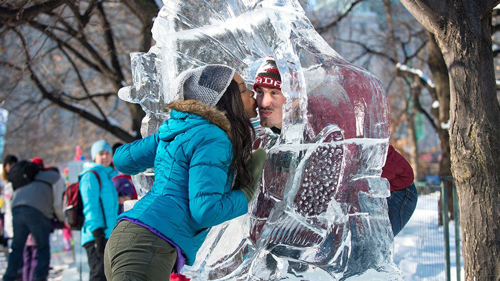 Two people kissing at an ice sculpture in Ottawa